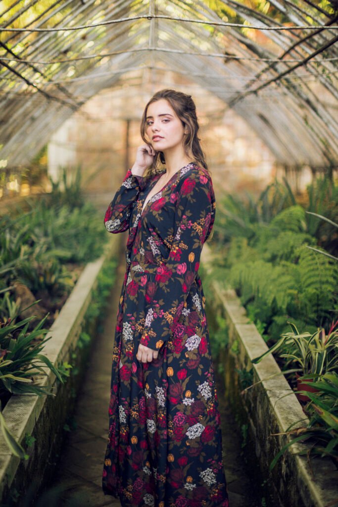 sideways woman posing green house